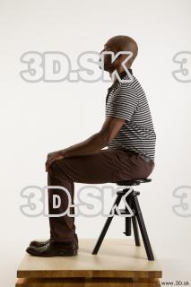 Sitting reference of whole body black white striped shirt brown…